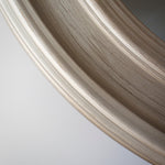 Close up of distressed silver around the edges of the round mirror