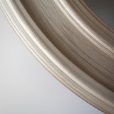 Close up of distressed silver around the edges of the round mirror