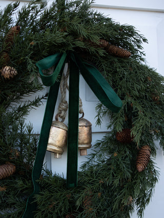 Close detail of feathery faux cedar sprigs and pinecones on the Ashdown wreath