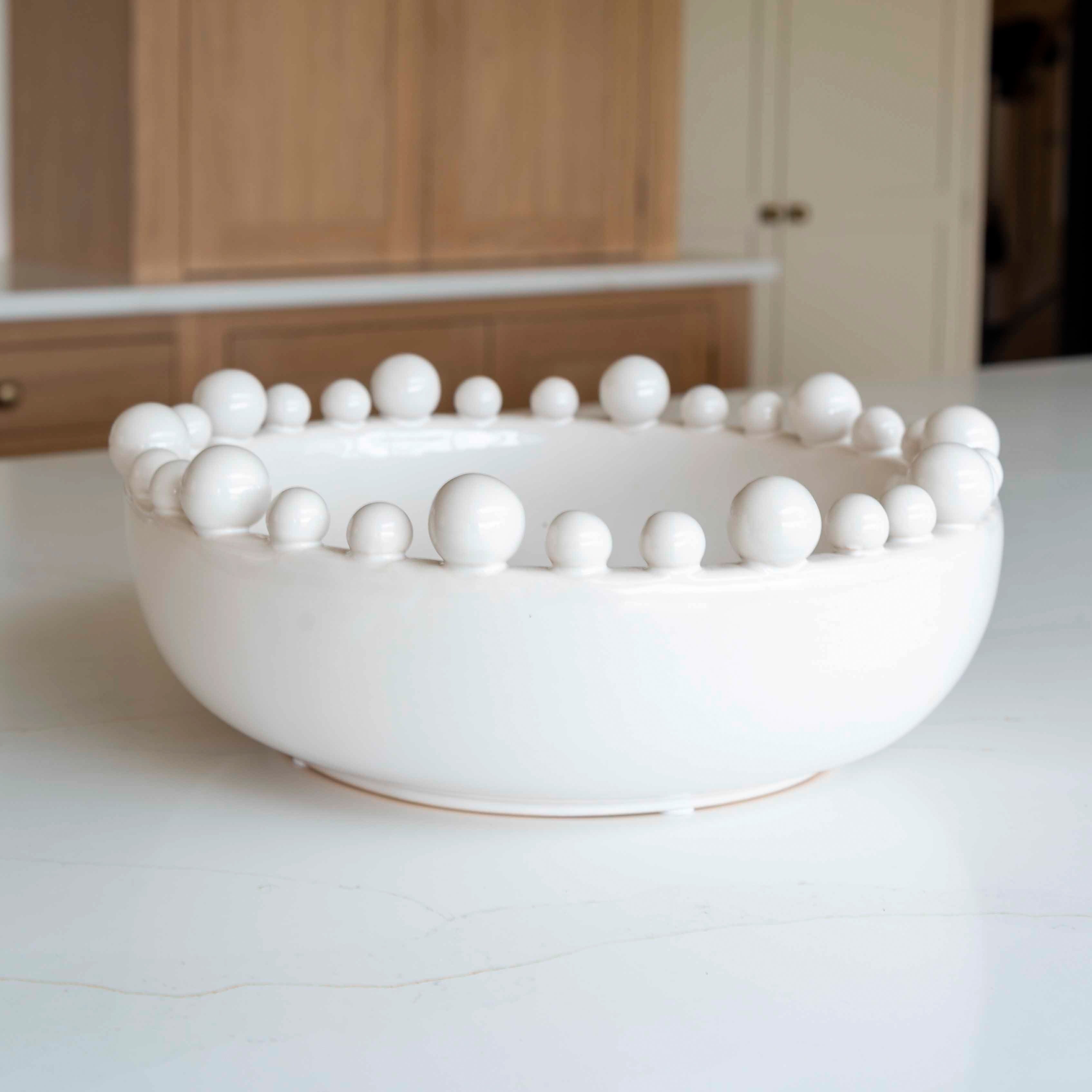 White bobble rim ceramic bowl styled in kitchen