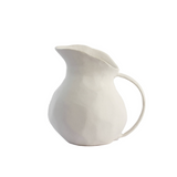 White ceramic pitcher on a white background