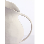 Close-up of a beige ceramic pitcher on a white background