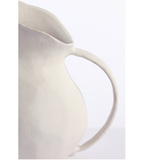 Close-up of a beige ceramic pitcher on a white background