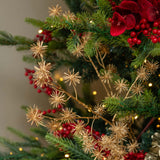 Decorative Christmas tree with red berries and gold branches against a blurred background