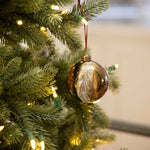 Charles Ted Marble Glass Baubles in bronze and cream tones hanging on a Christmas tree
