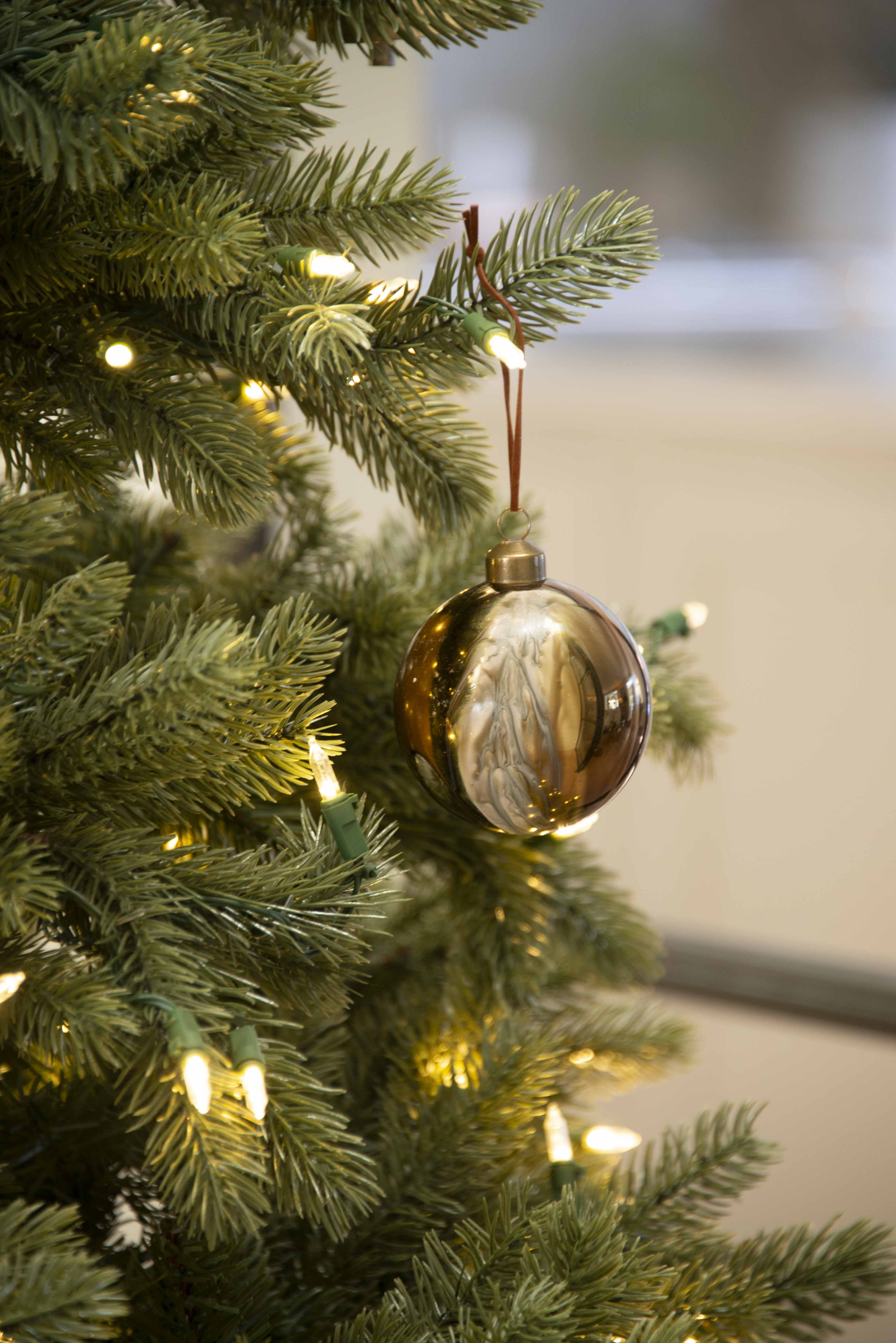 Charles Ted Marble Glass Baubles in bronze and cream tones hanging on a Christmas tree
