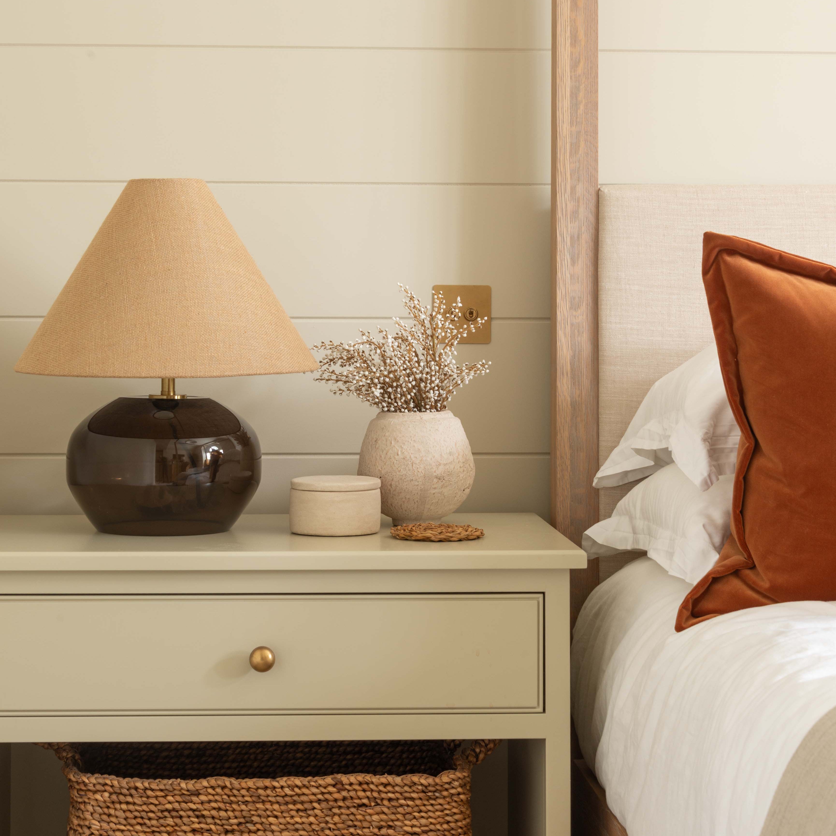 a rounded smoked amber glass base paired with a textured woven fabric shade