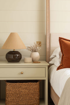 a rounded smoked amber glass base paired with a textured woven fabric shade