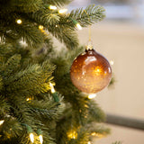 Charles Ted bauble hanging on Christmas tree with lights