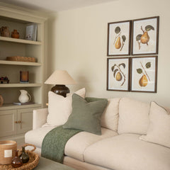 Framed pear wall art set displayed in a living room