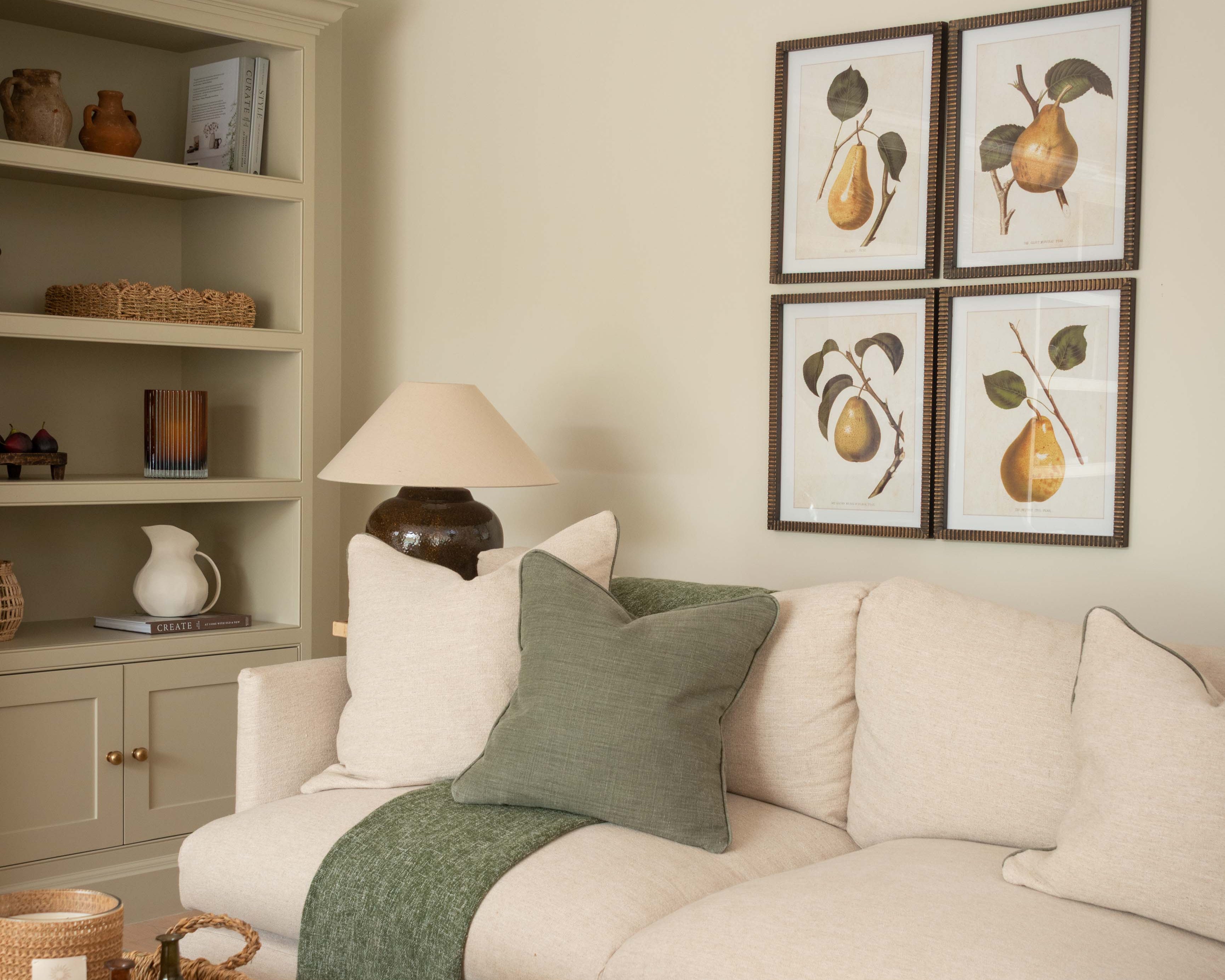 Framed pear wall art set displayed in a living room