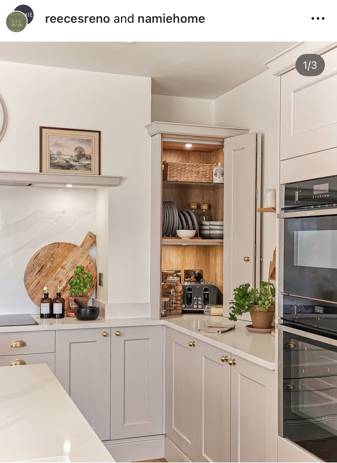 Modern kitchen with white cabinets, stainless steel appliances, and a countertop with various items.