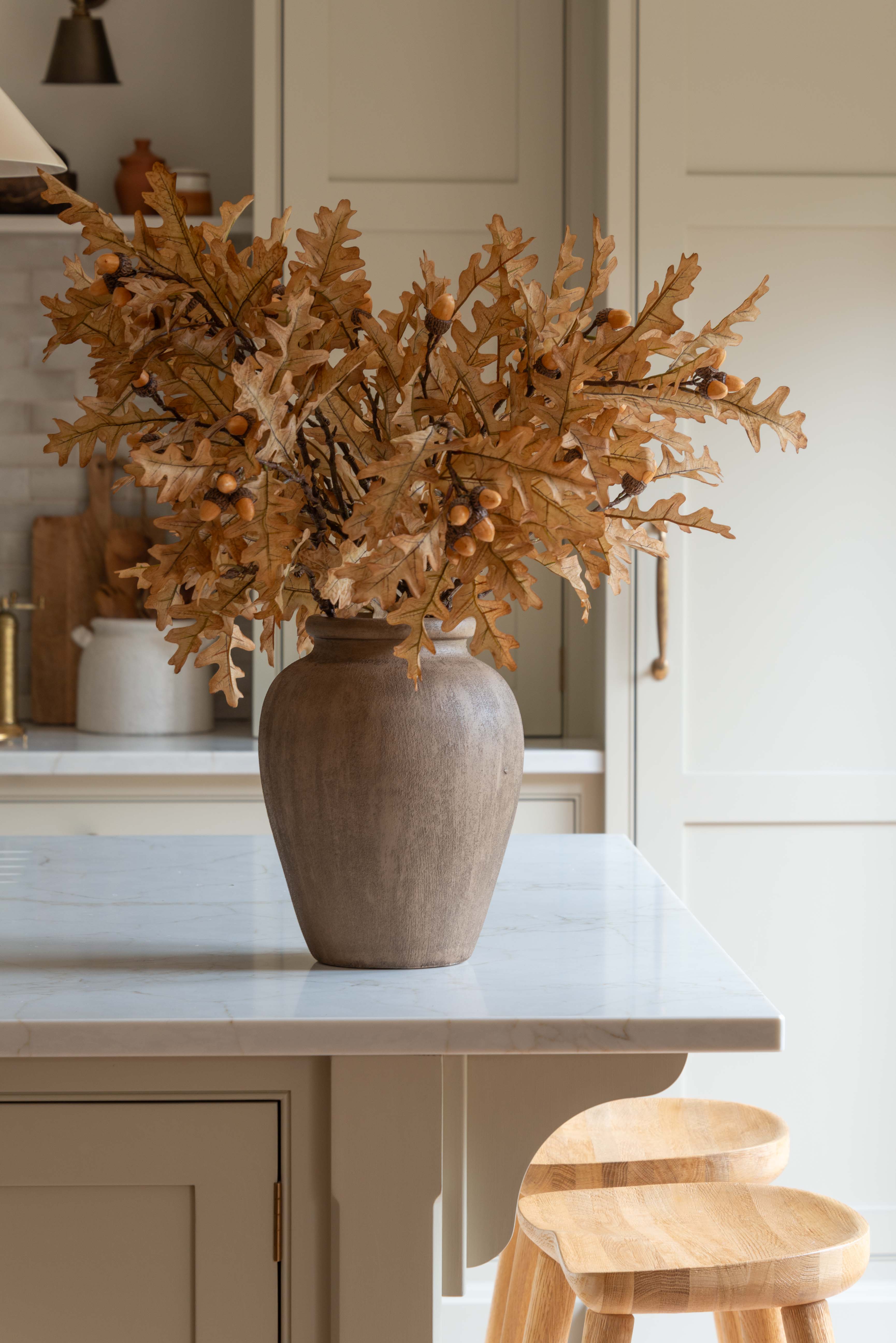 Decorative vase with dried foliage on a kitchen counter