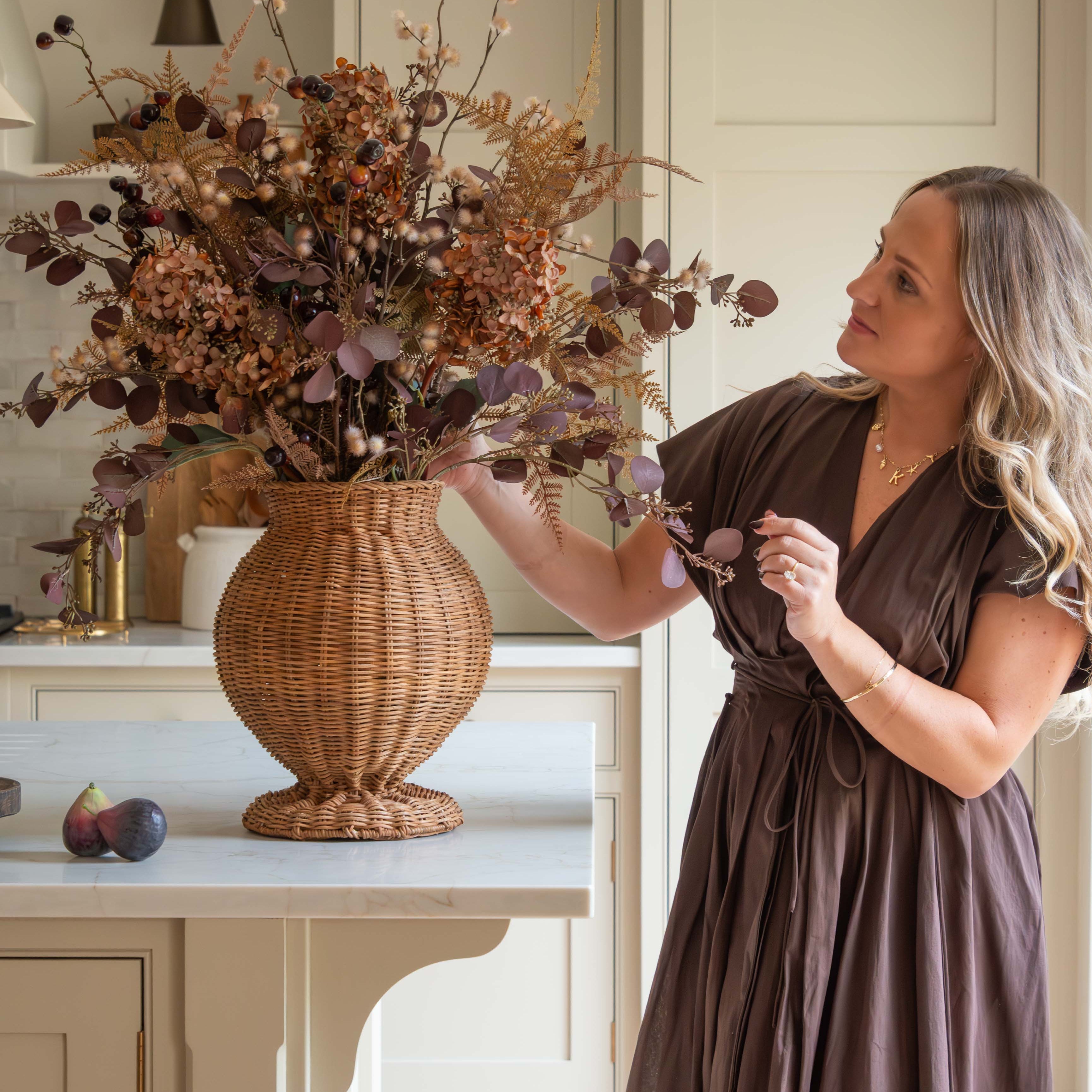 Charles Ted Shola Rattan Vase styled with autumn floral arrangement on kitchen island