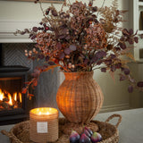 Handwoven Charles Ted Shola Rattan Vase with figs and candle by fireplace