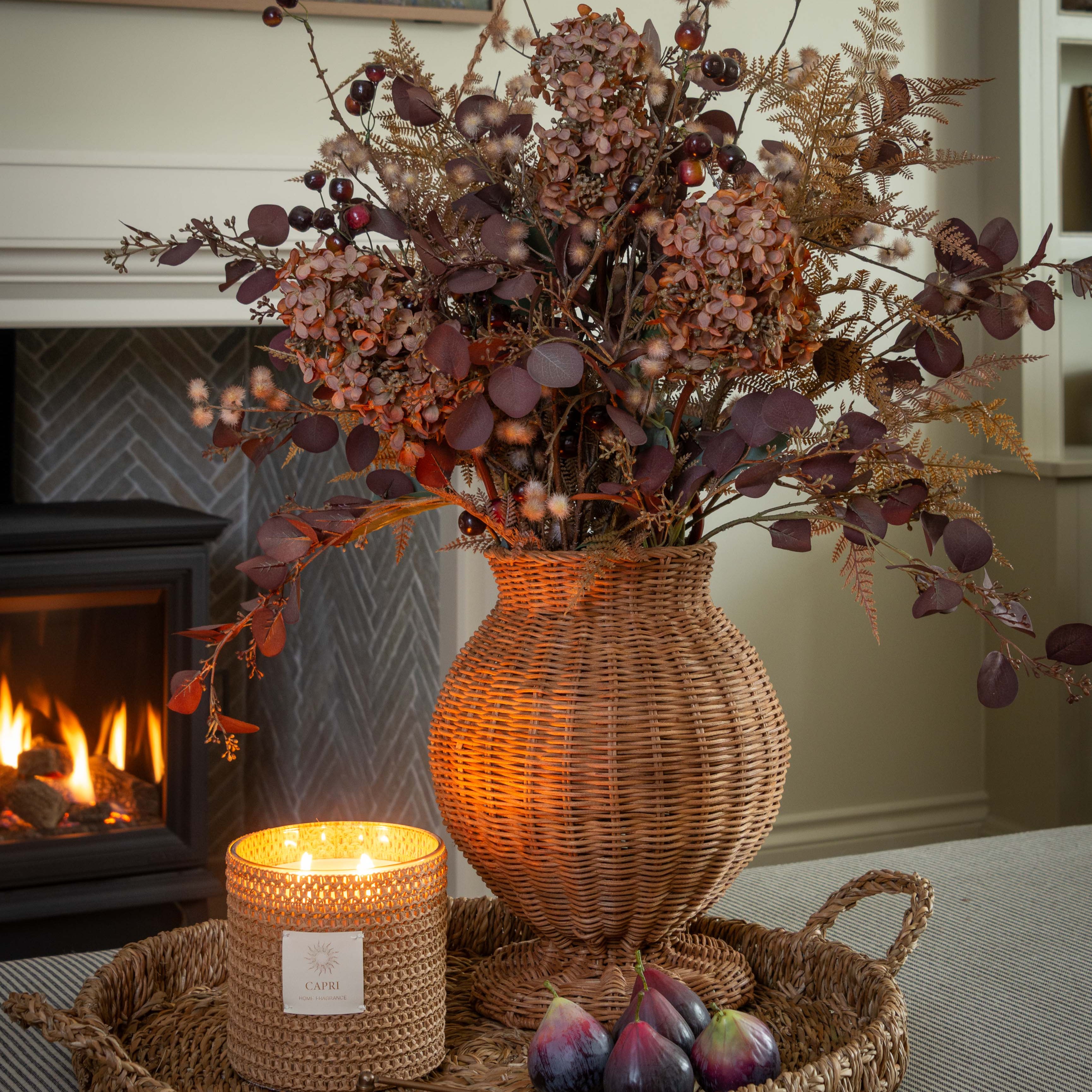 Handwoven Charles Ted Shola Rattan Vase with figs and candle by fireplace