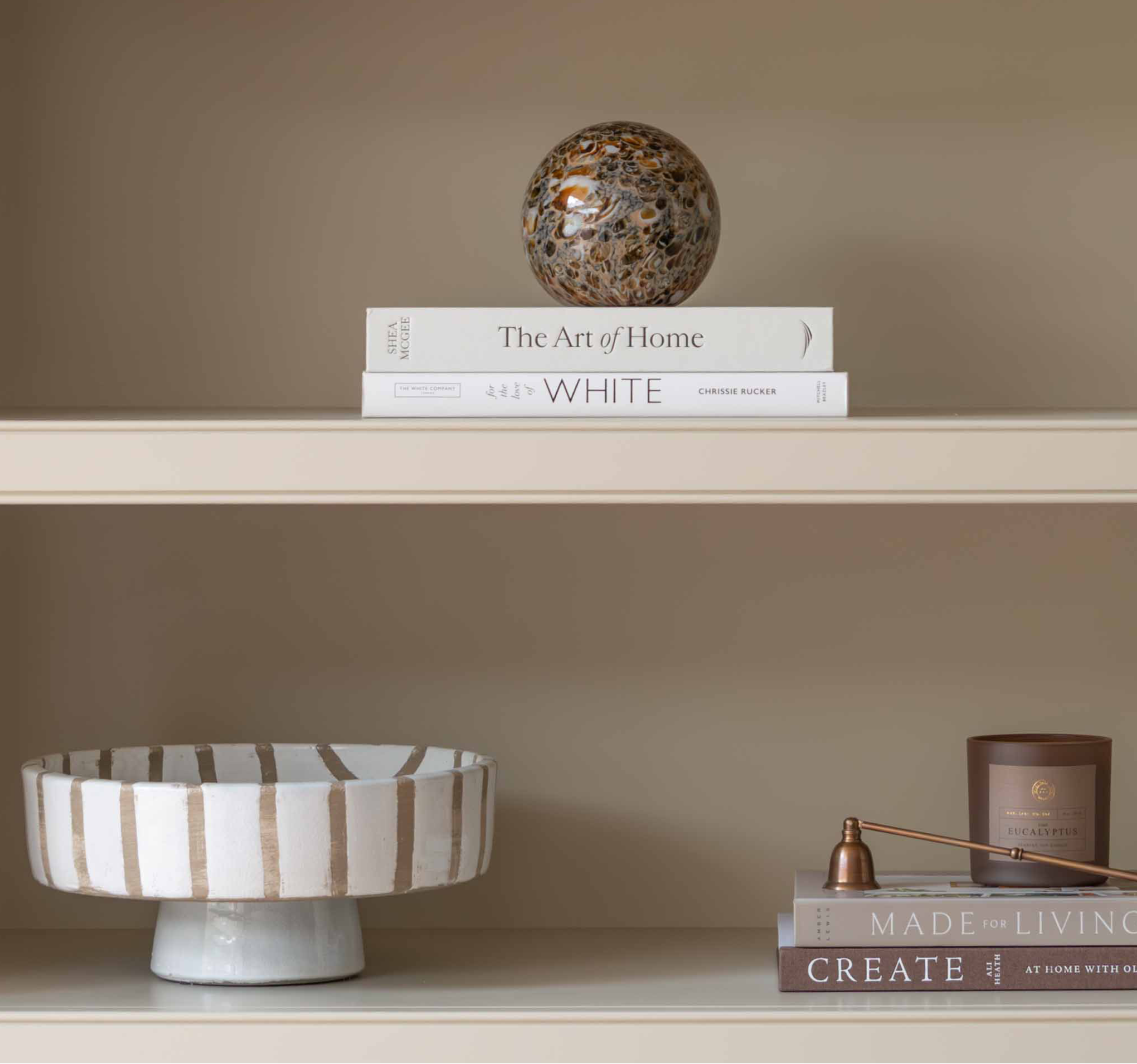 Charles Ted Striped Footed Terracotta Bowl with vertical neutral stripes displayed on a shelf