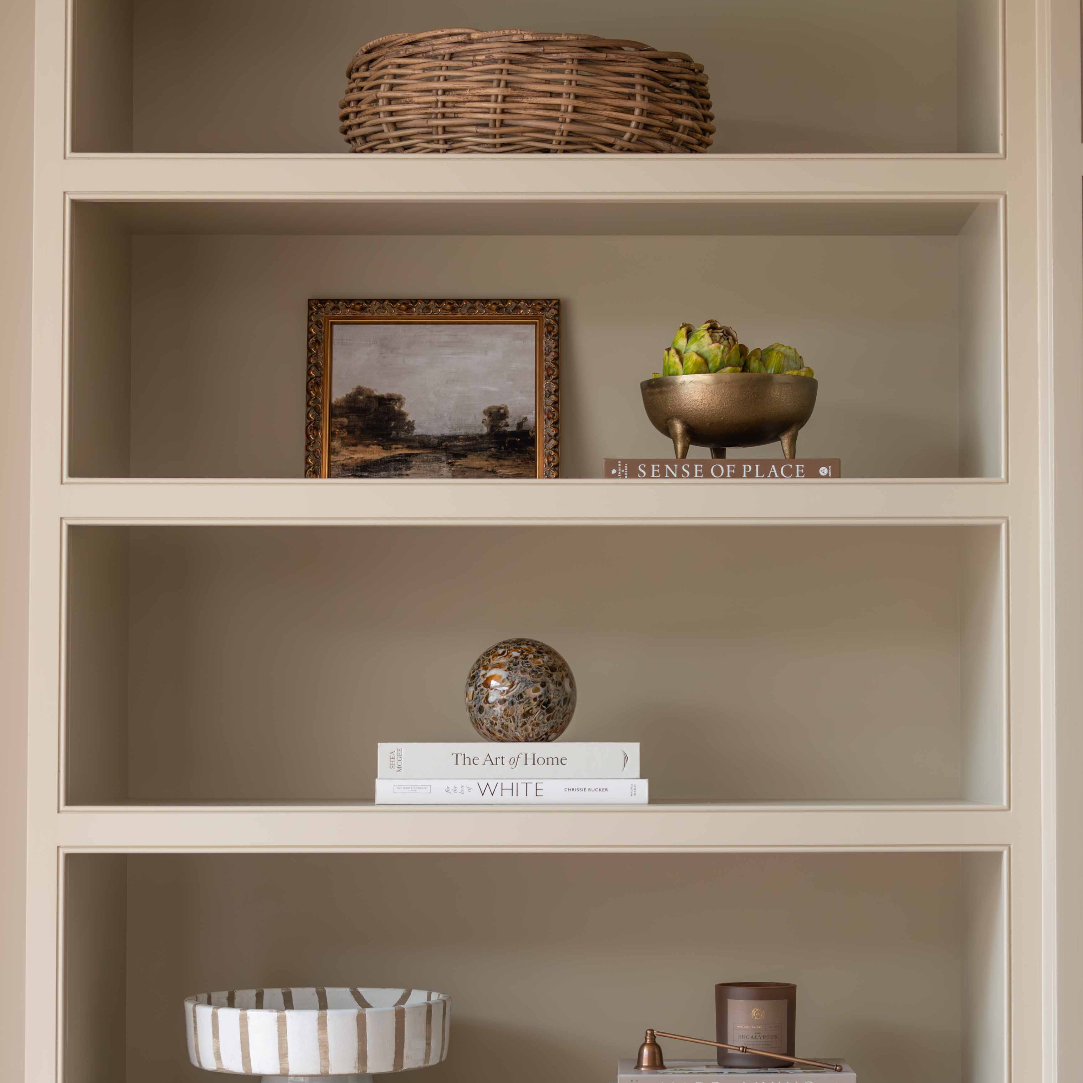 Charles Ted Striped Footed Terracotta Bowl with vertical neutral stripes displayed on a shelf