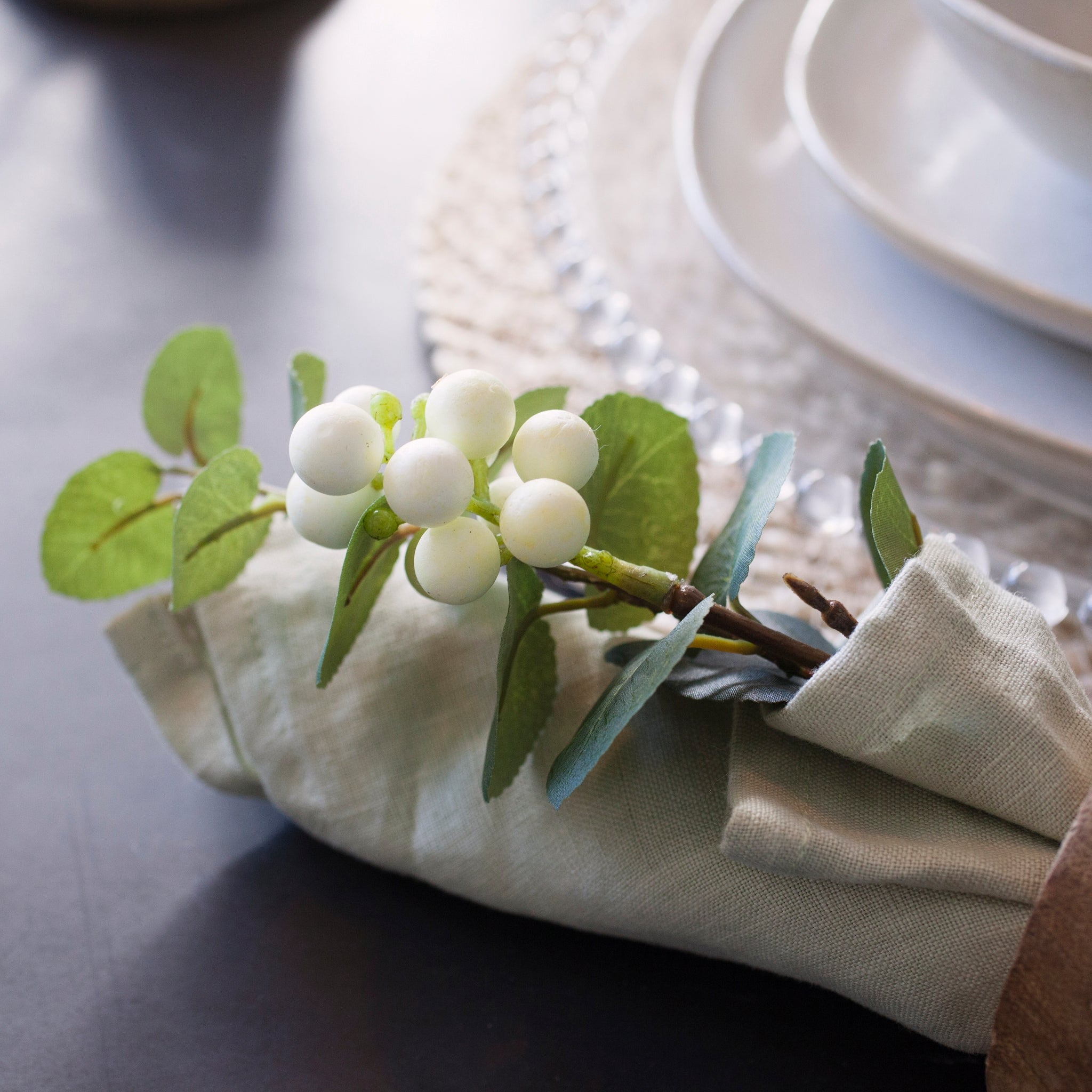 White snowberry spray napkin decoration for elegant table setting