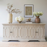 Crafted from recycled pine, this cabinet showcases four doors adorned with bronze metal handles and a rustic finish.