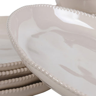 Close-up of the raised beaded rim detail on a taupe dinner plate