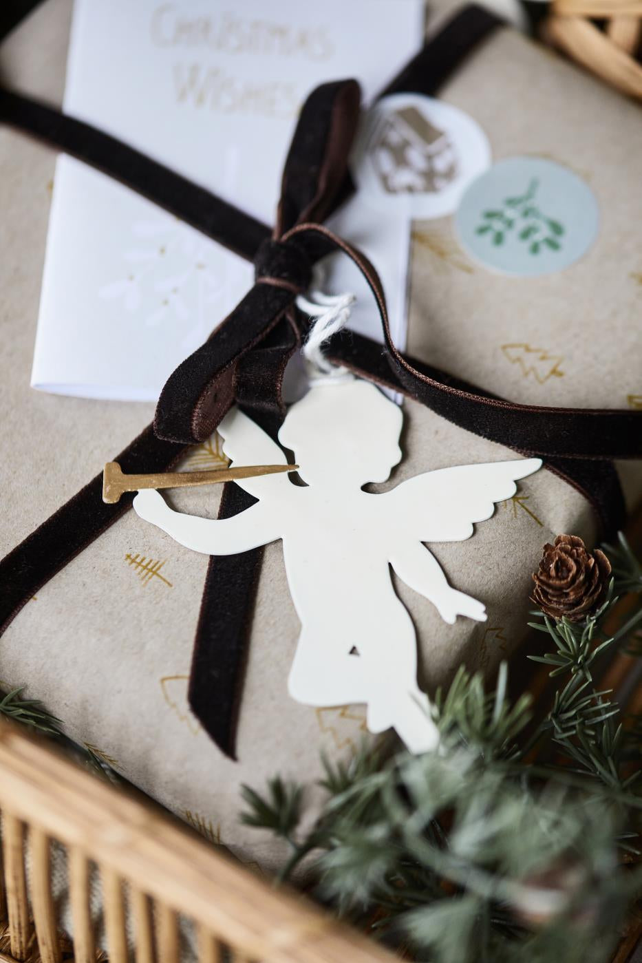 Gift wrapped in brown velvet ribbon with angel ornament