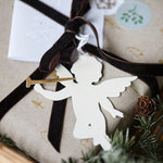 Gift wrapped in brown velvet ribbon with angel ornament