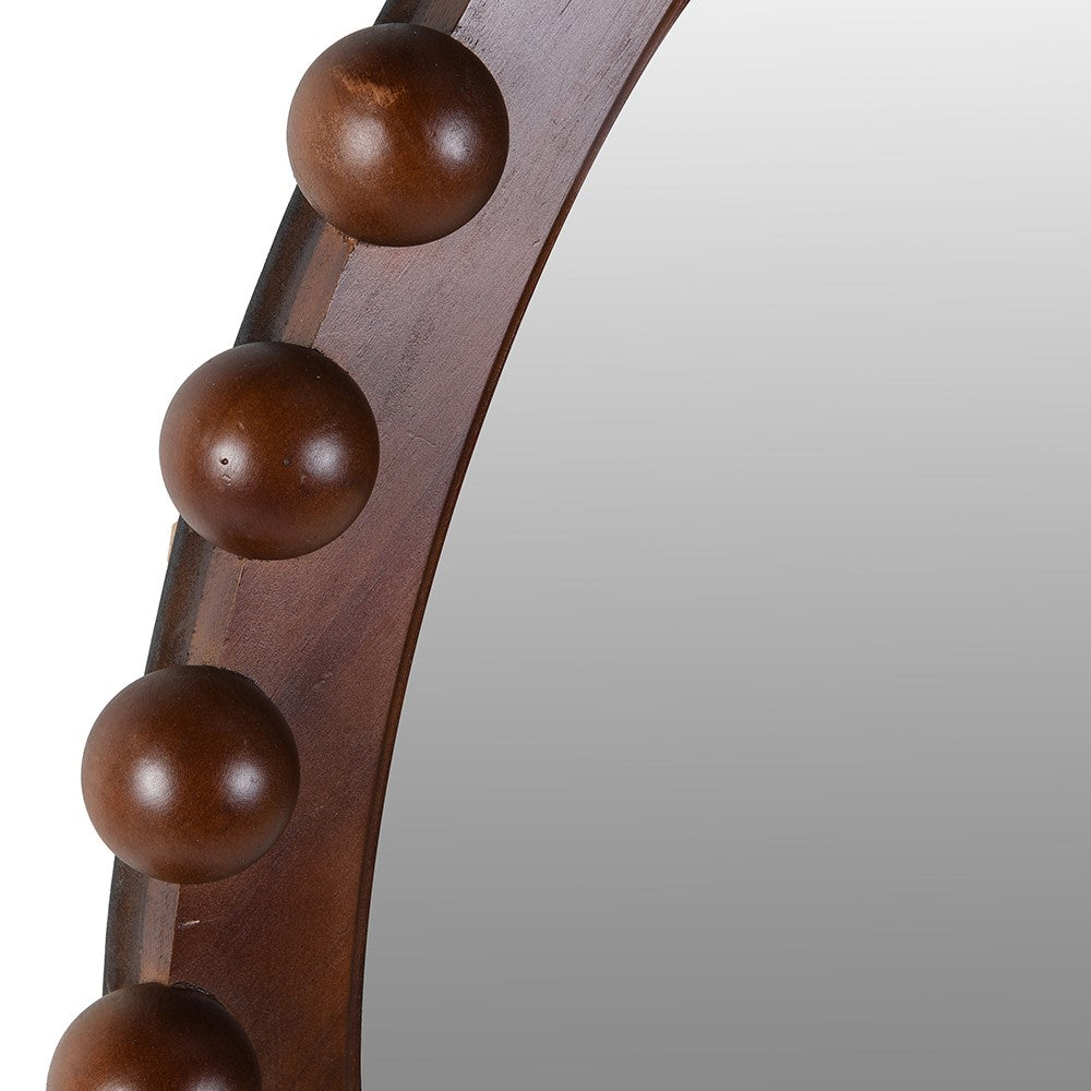 Round wooden mirror with chestnut-style orb frame close up 