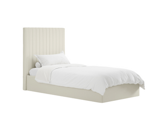 A single bed with a tall, vertically channel-tufted upholstered headboard and matching base, dressed in white bedding, shown on a plain white background.