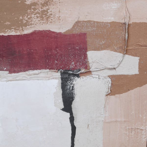 Close-up view of textured abstract wall art in earth tones with maroon, beige, white, and black layers.