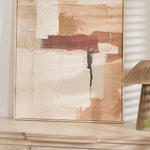 Abstract wall art styled on a light wood console with neutral home decor