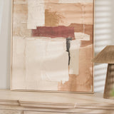 Abstract wall art styled on a light wood console with neutral home decor