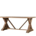 Wooden dining table with X-shaped base on a white background