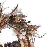Close-up of dried autumn wreath featuring pinecones, seed pods, and textured foliage in brown and gold hues