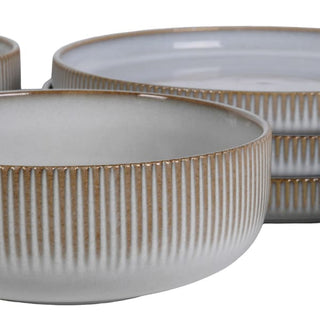 Close-up of the vertical reeded detail on a fluted earthenware bowl
