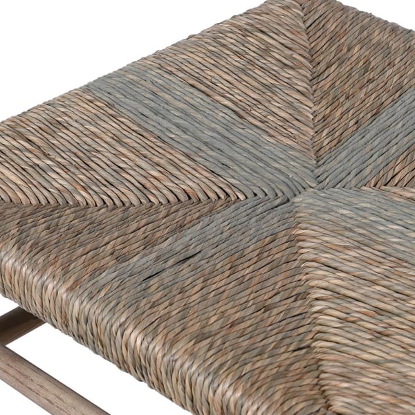 Close-up of woven seagrass seat detail on rustic dining chair