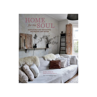 Book cover featuring a rustic living room with wide couch and decorative recycled wood finishings