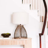 Fisherman cage lamp featuring a metal mesh base and a white lampshade