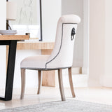 A striking dining chair in natural linen with stun detailing and ring back.