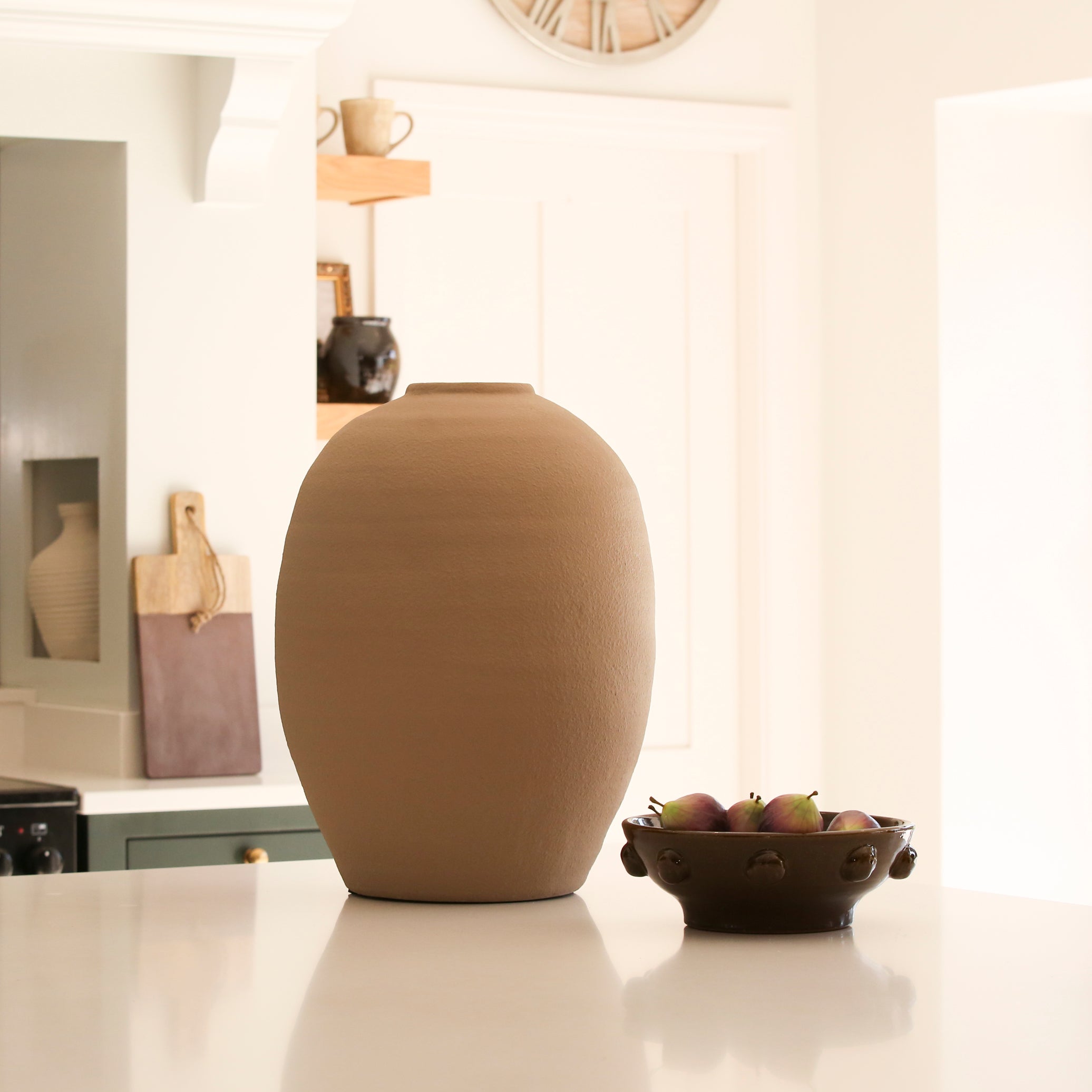 An elongated beige vase