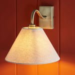 Dunston Antique Brass Wall Light with linen cone shade close up