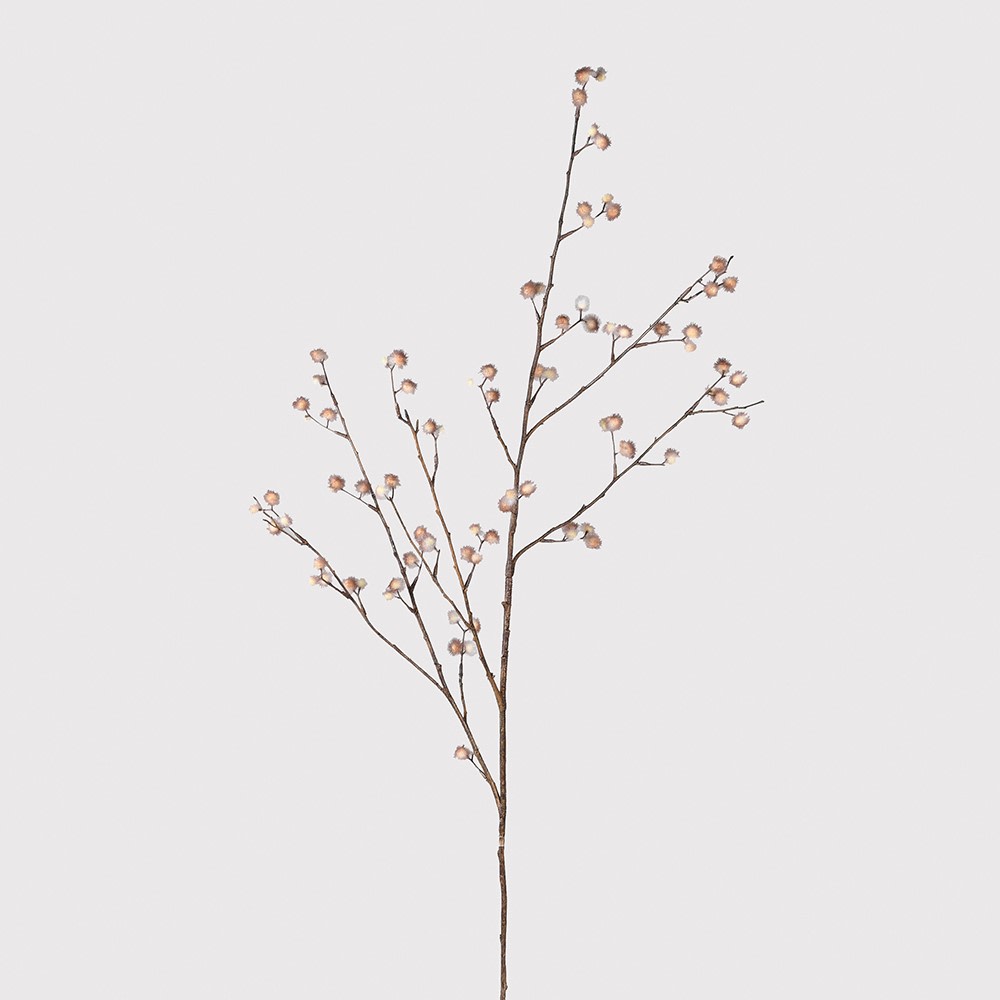 Decorative branch with small flowers on a light gray background