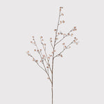 Decorative branch with small flowers on a light gray background