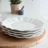 12-piece set of white ceramic scalloped dinner service.