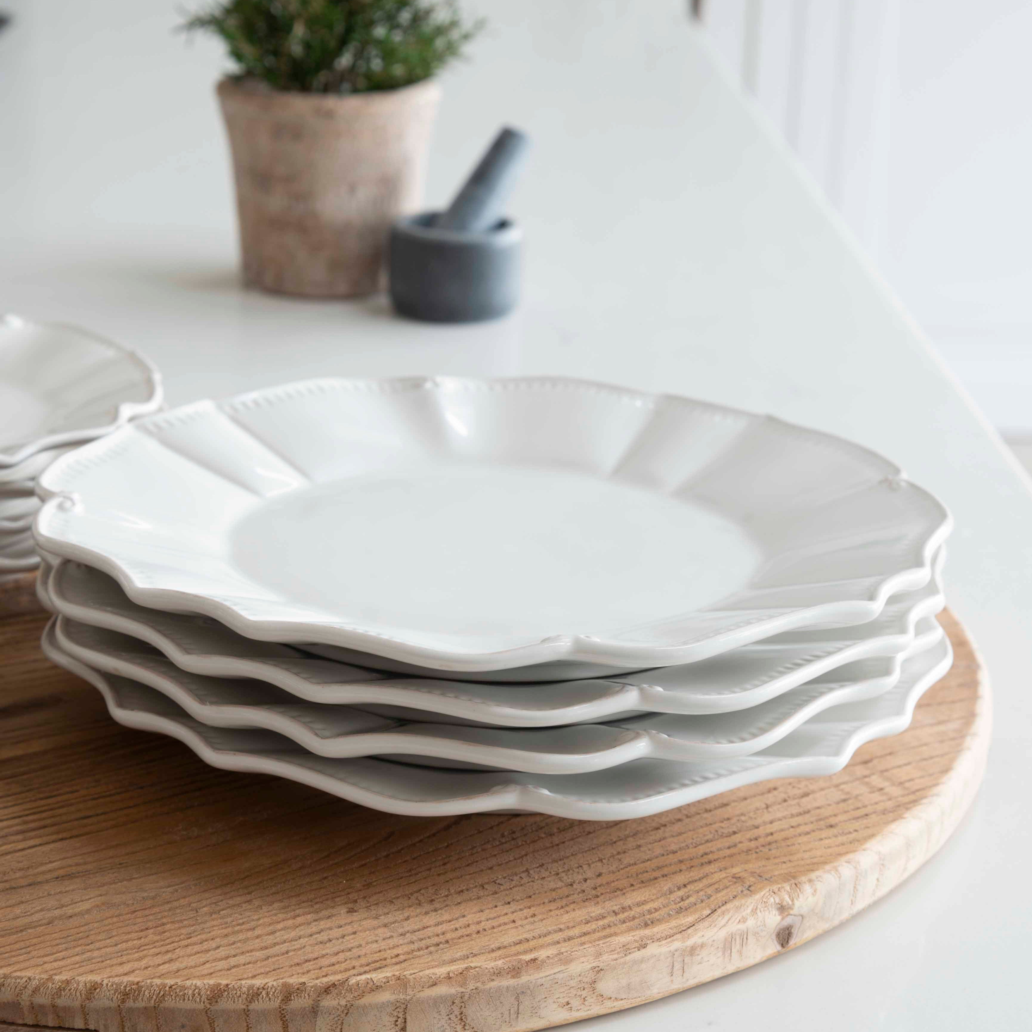 12-piece set of white ceramic scalloped dinner service.