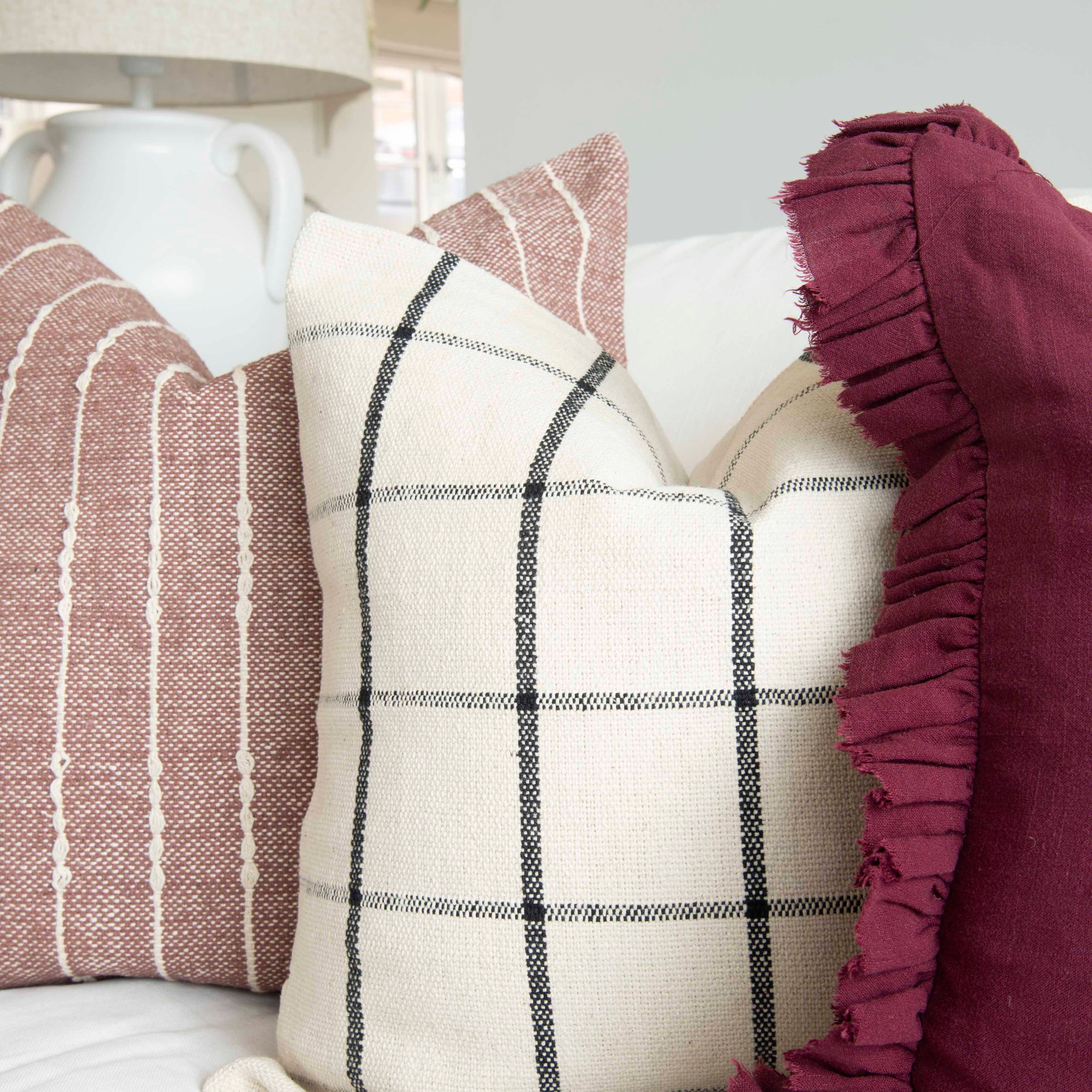 A stunning cotton cushion with a beautiful check detail. Displayed here alongside other cushions