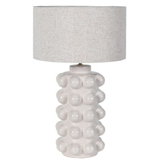 Eldon white bobble table lamp with a sculptural ceramic base studded with bobbles and a natural linen drum shade, photographed against a white background