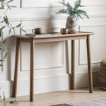Full view of the Elmore Oak Console Table styled in a bright hallway with neutral decor