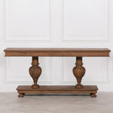 Ernest console table crafted from white cedar stained in a rich brown finish with carved column legs and beaded edge detail
