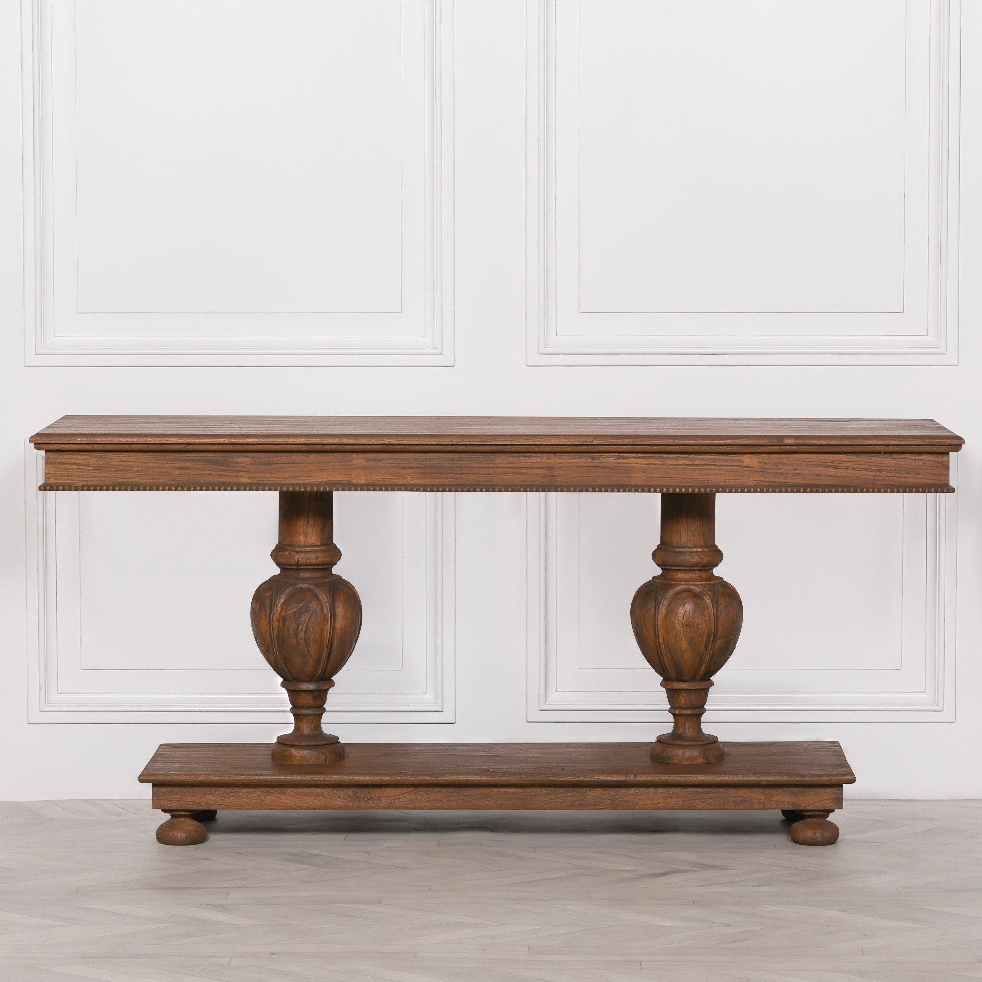 Ernest console table crafted from white cedar stained in a rich brown finish with carved column legs and beaded edge detail